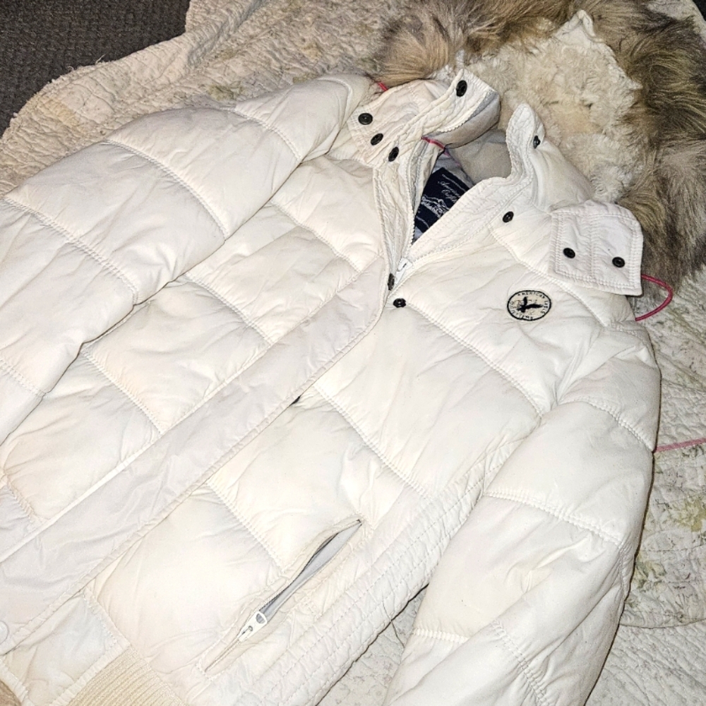 White puffy winter coats with furry trim that is removable